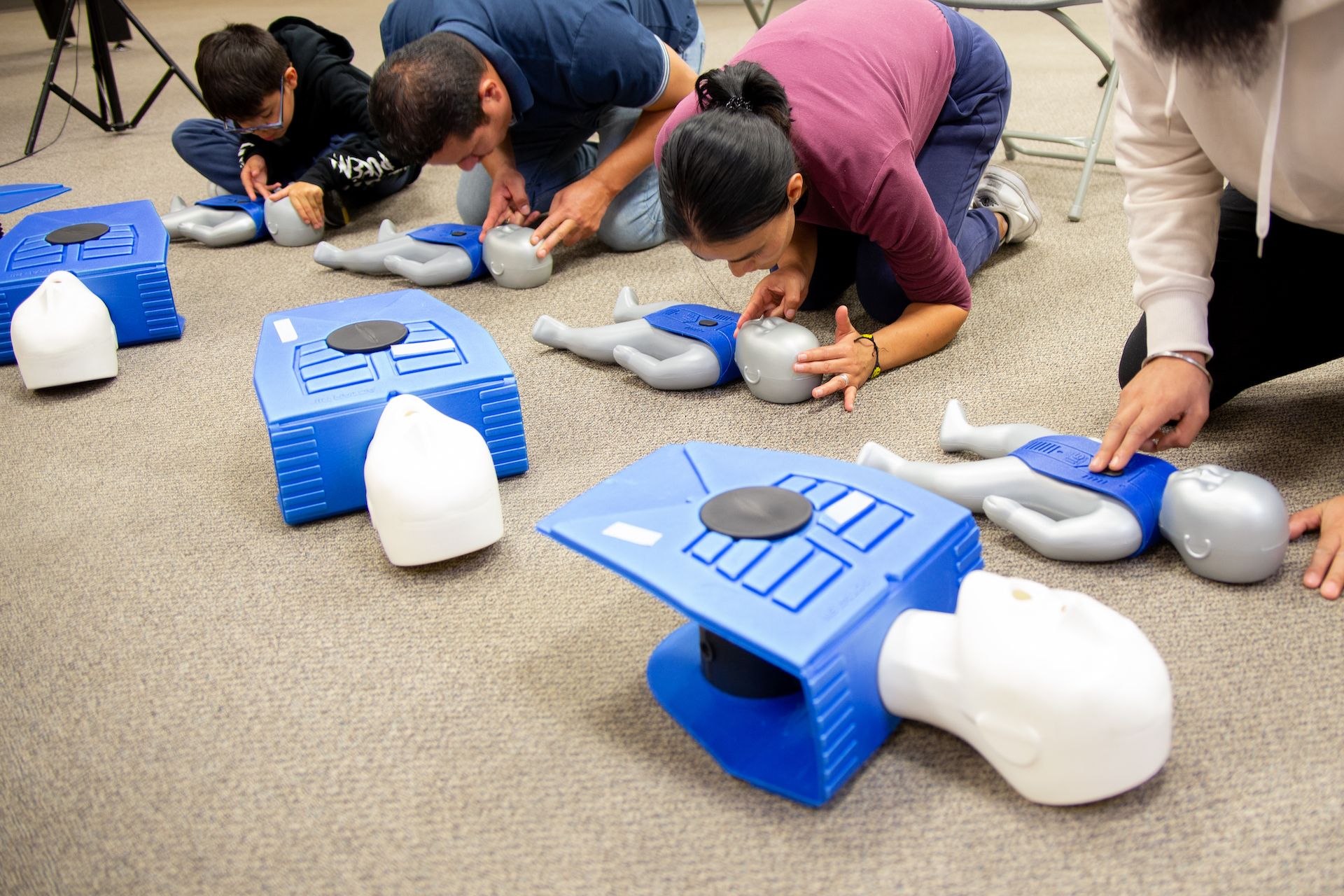 A group of First Aid and CPR trainees learning using dummies / mannequins at Flex Point Academy