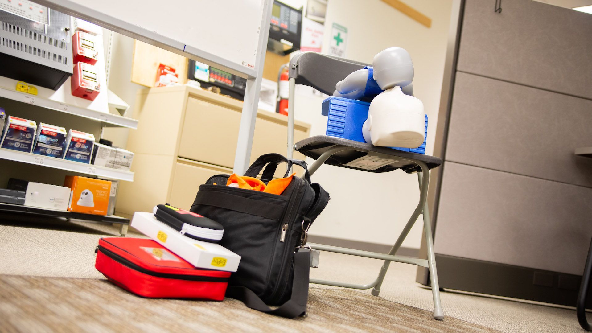 First Aid and CPR training equipment placed on a chair and also next to it at Flex Point Academy's office in Etobicoke, Ontario