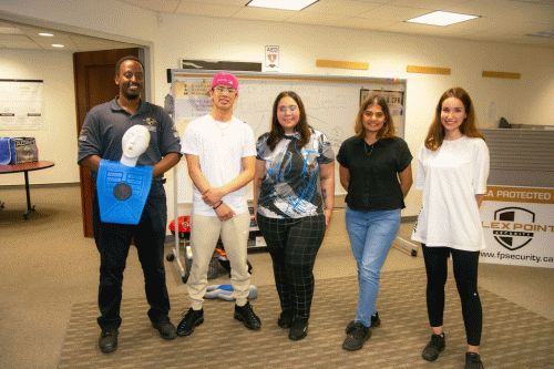 4 Flex Point Academy First Aid & CPR trainees standing next to an instructor upon completion of their training