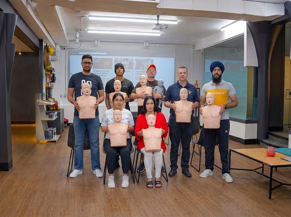 4 Flex Point Academy First Aid & CPR trainees standing next to an instructor upon completion of their training