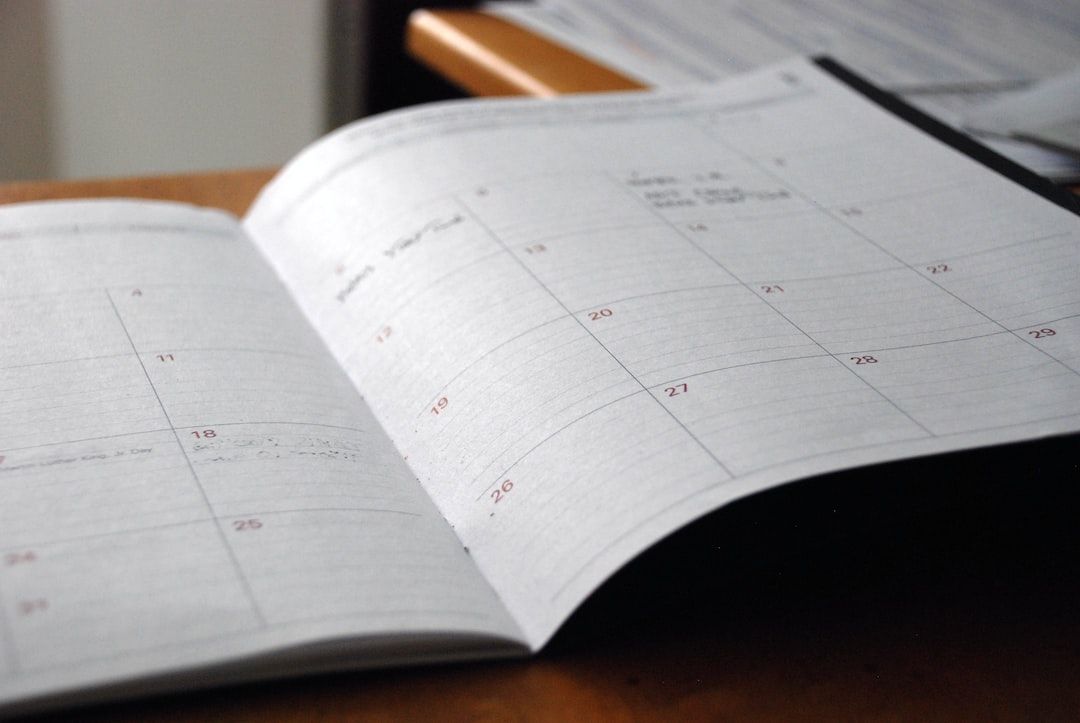 An open paper calendar on a wooden table