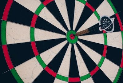 Dartboard with dart in the bullseye