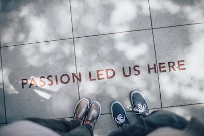 Text on the floor reading "passion led us here"