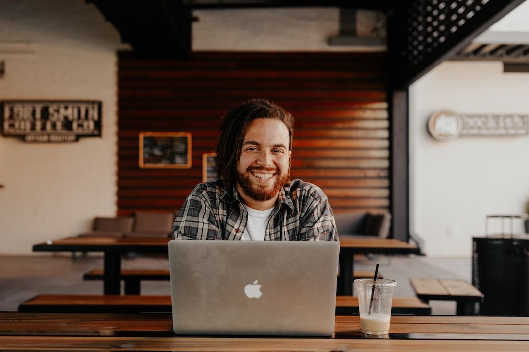 Man smiling at laptop