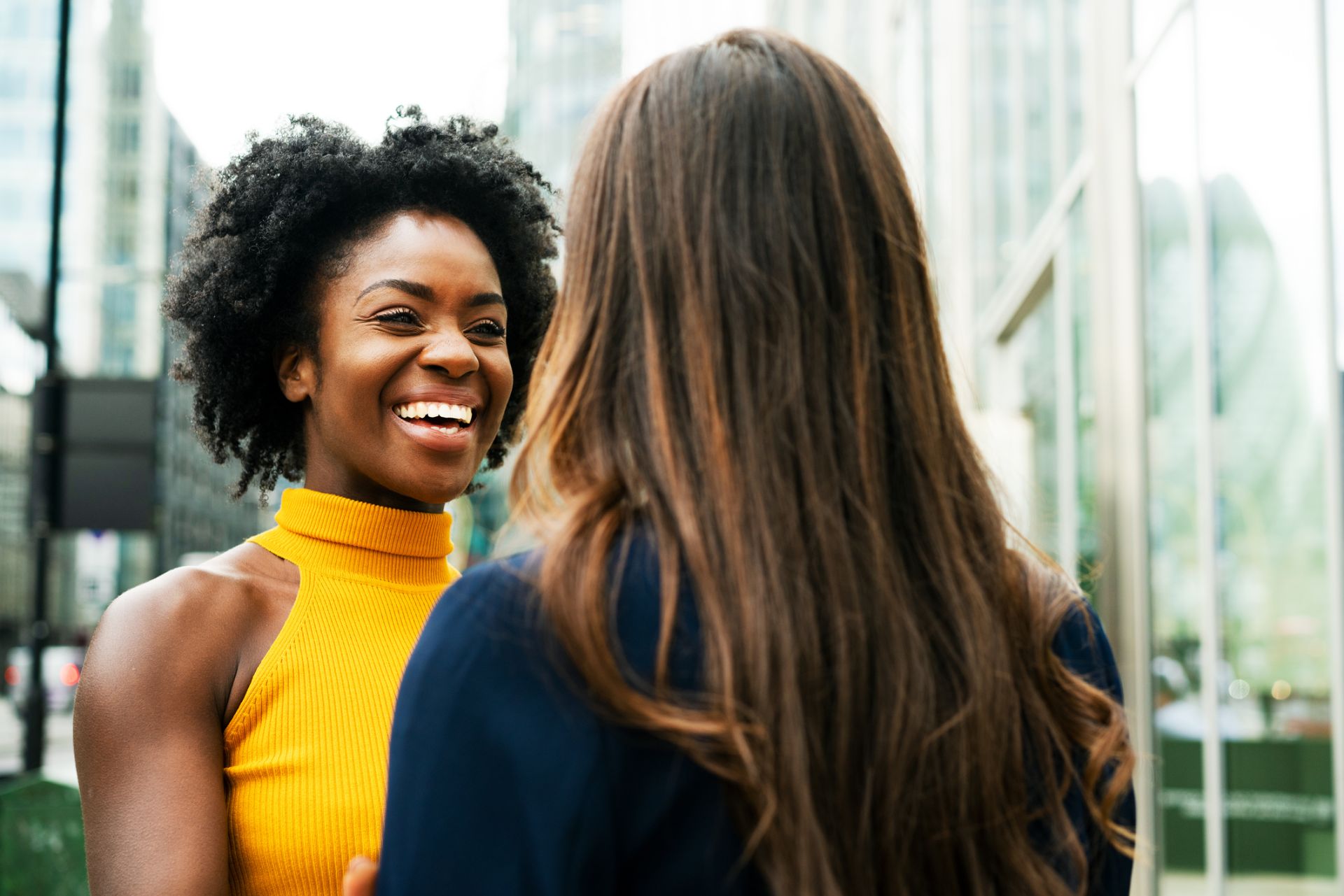 Two people talking and smiling