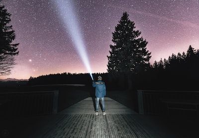 Person with torch lighting up to the sky