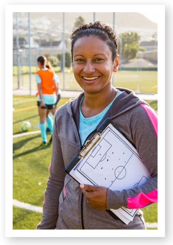 Female teacher with clipboard, smiling
