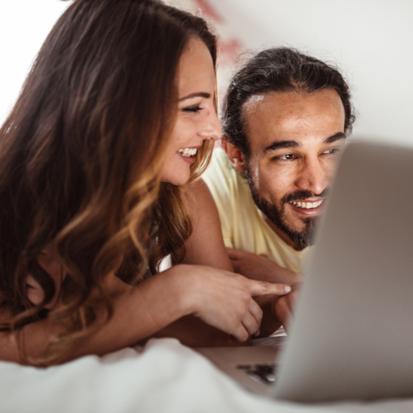 Man and woman at computer smiling