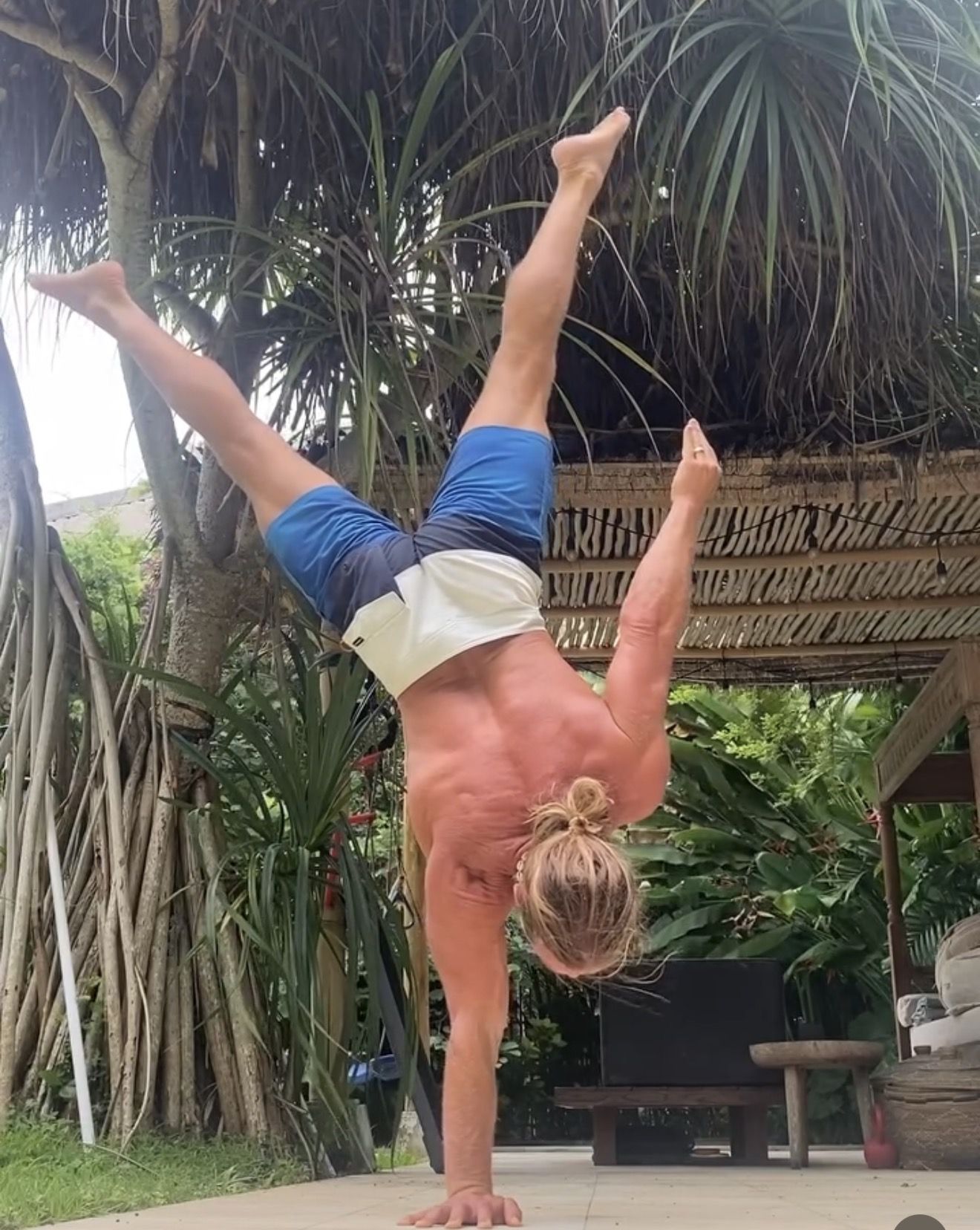 AoH student holding a one-arm handstand
