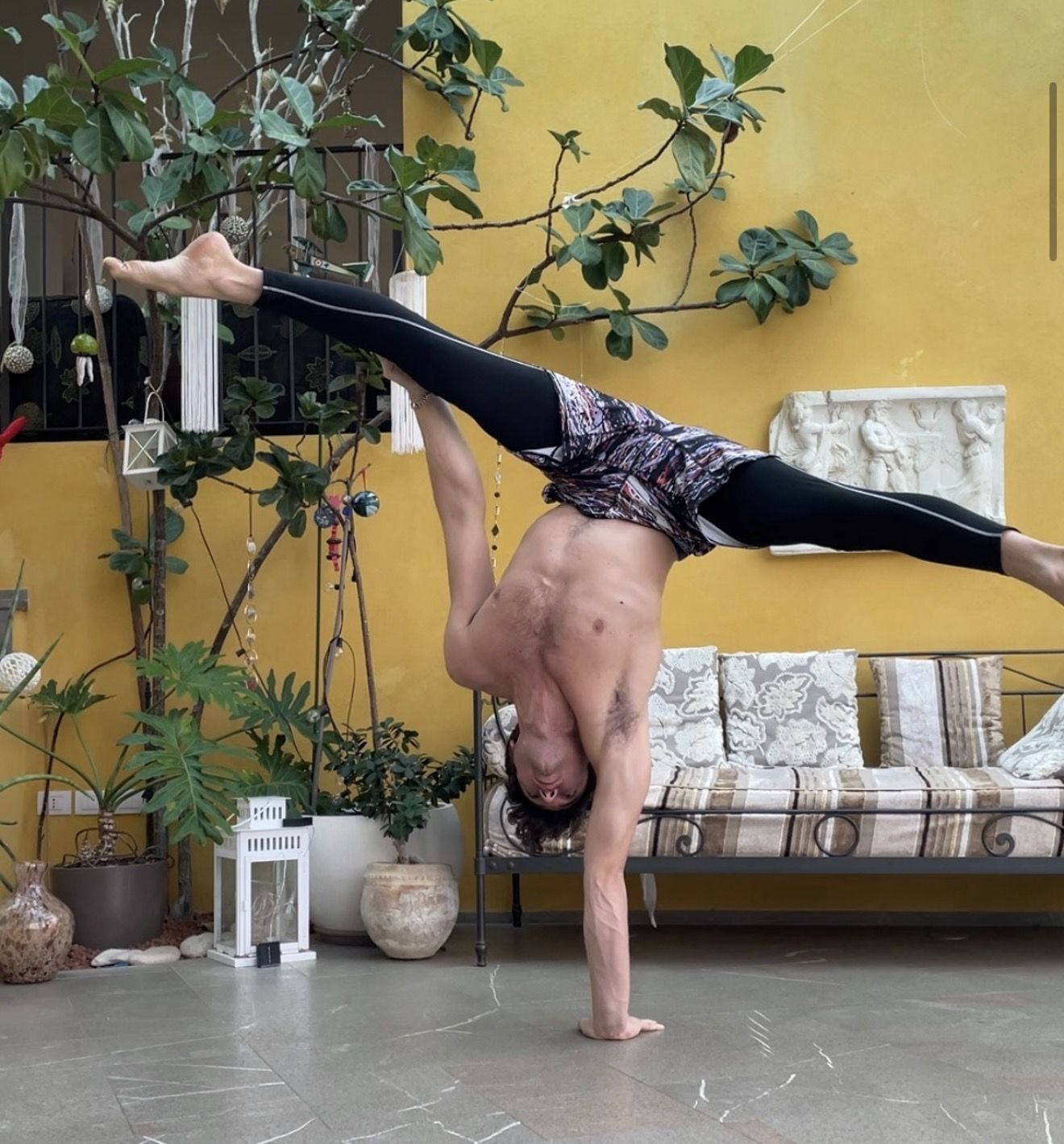 AoH student holding a one-arm handstand