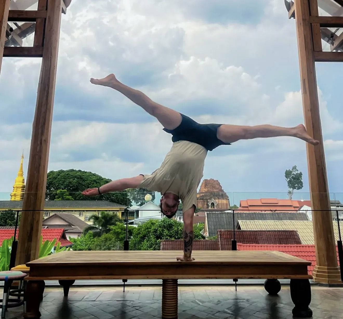 AoH student holding a one-arm handstand