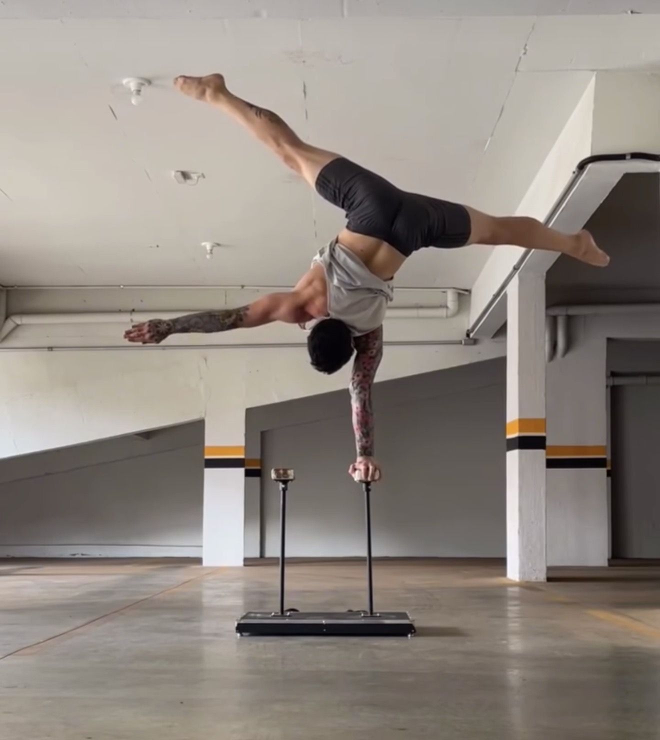 AoH student holding a one-arm handstand