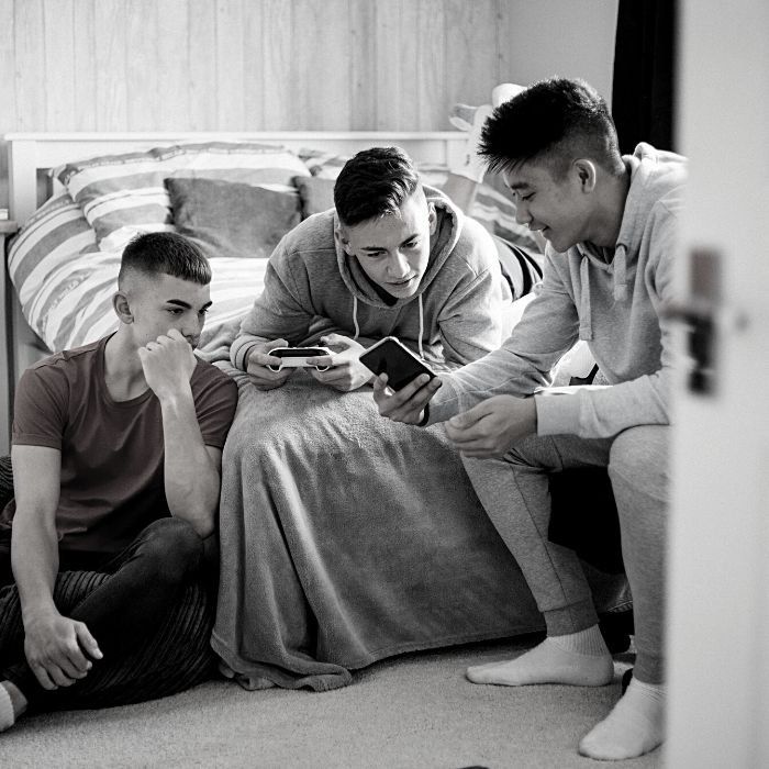 Teens hanging out in a bedroom