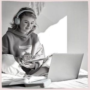Girl sitting on a bed, studying