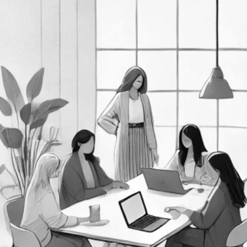 Women sitting at table with laptops