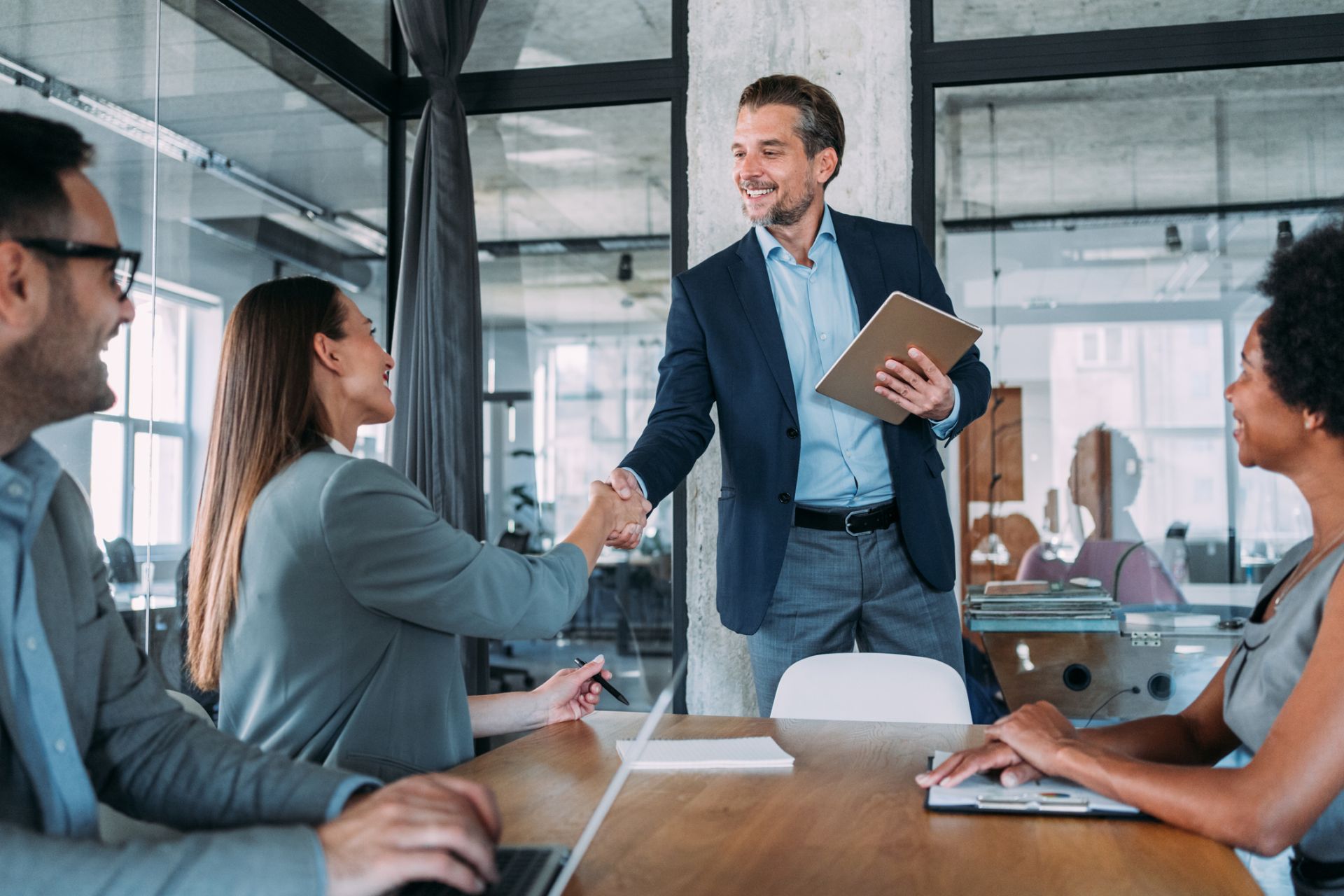 man and woman shaking hands in a meeting