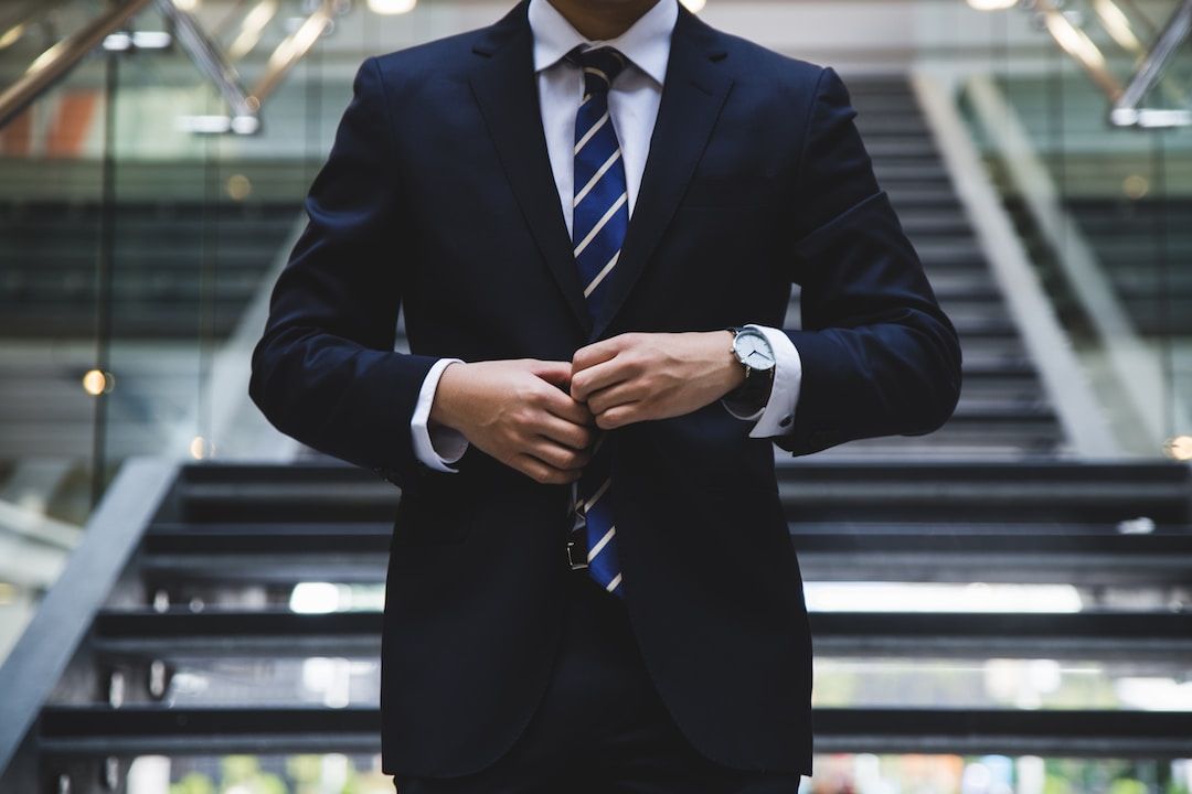 Man in suit stood in front of stairs