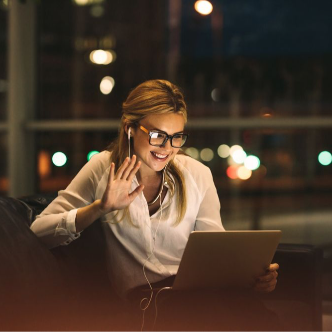 Woman on a video call using a digital device. She is seen engaging in a conversation with the screen displaying a video call interface, representing remote communication and connectivity in the digital age.