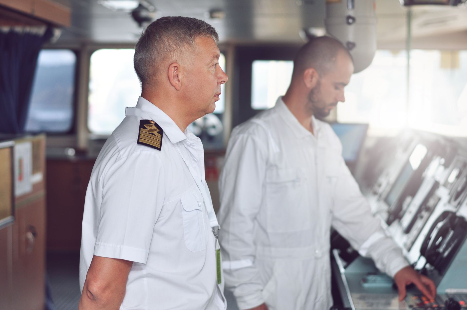 Senior maritime officer mentoring a fellow crew member, aligning with the collaborative spirit of the Mentoring and Peer Programme.