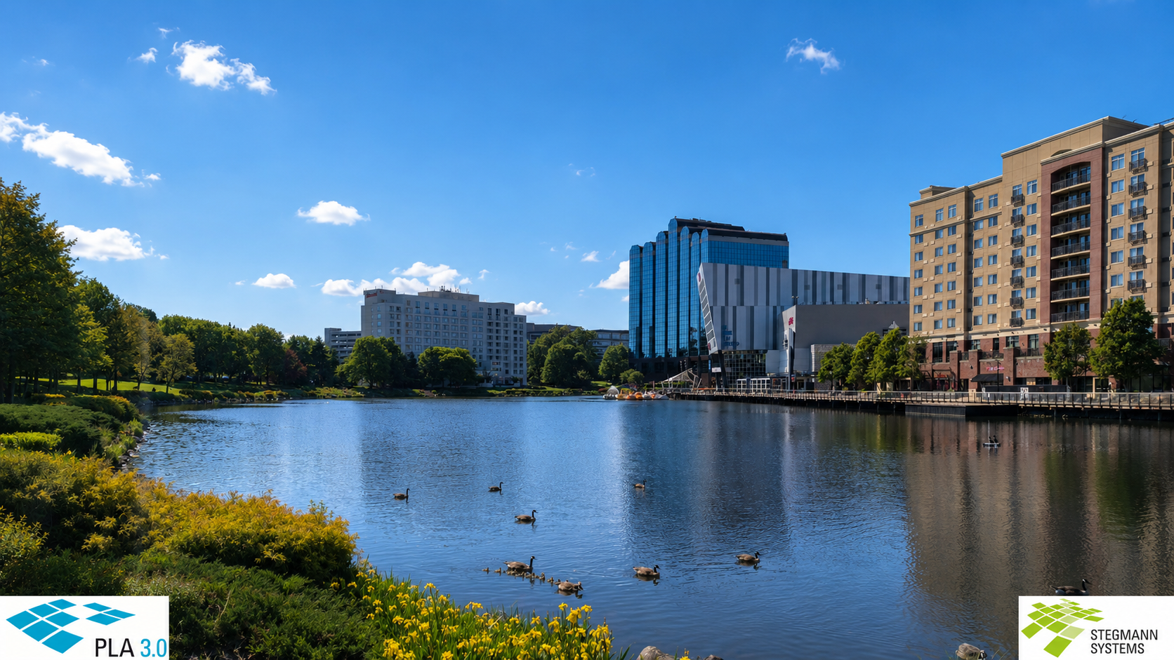 A lake and high modern buildings in the background, good weather