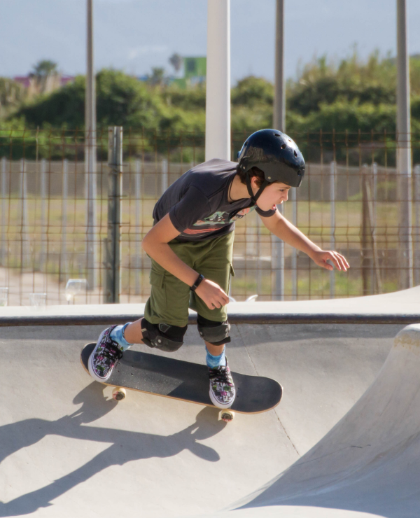 Teenage boy skateboarding at a skate park. 