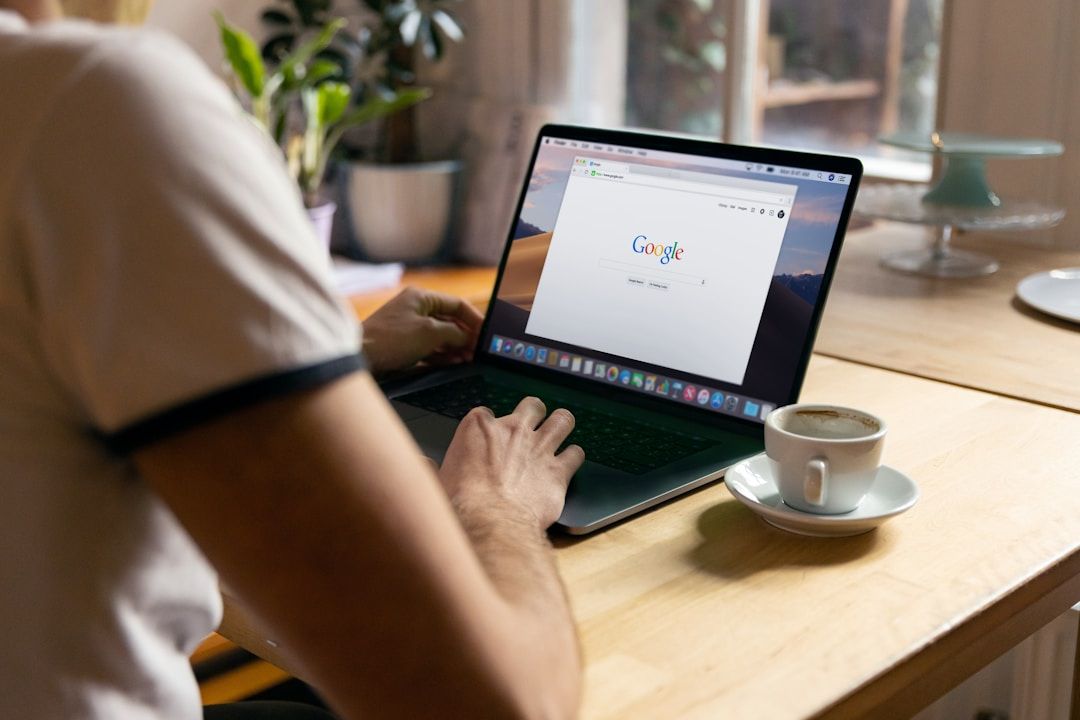 Person on a laptop accessing Google.com.