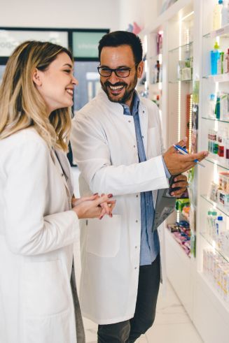 Pharmacy technician being trained by a pharmacist
