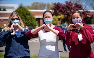 Registered nurses making a heart gesture to show compassion and teamwork during clinical practice