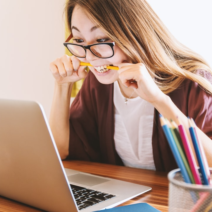 Woman looking frustrated at a laptop