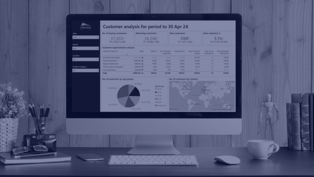 Screen on a desk showing a Power BI dashboard
