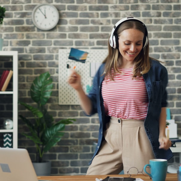 Woman dancing with joy in her office
