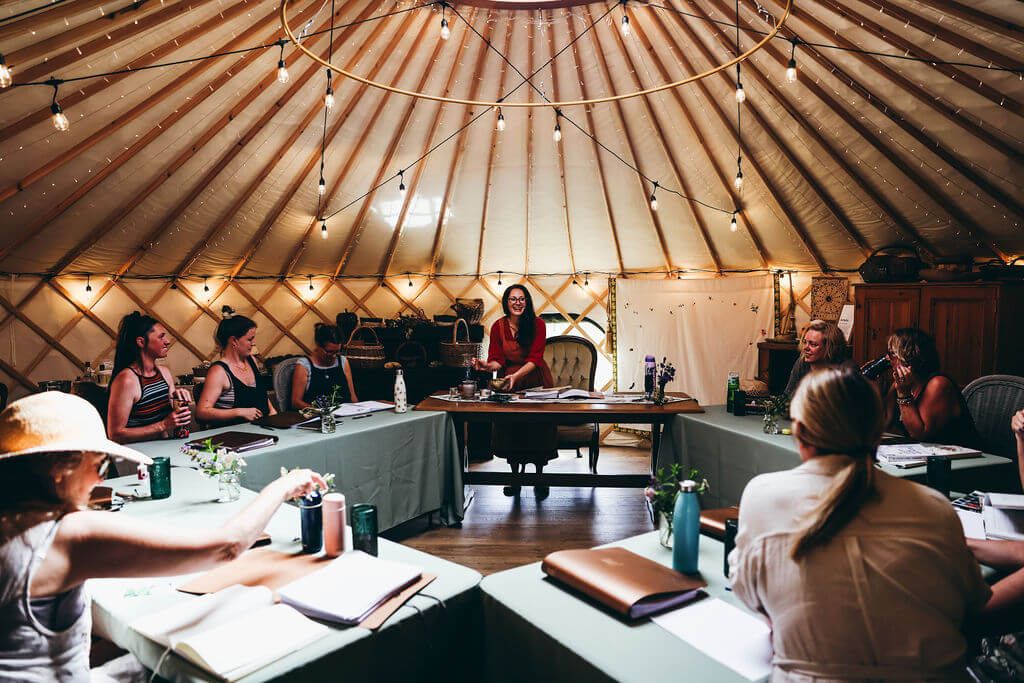 first-year students learning core herbalism concepts at our herbalism school yurt
