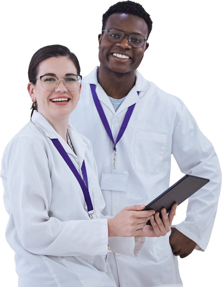 Two scientists in lab coats smiling and holding a tablet