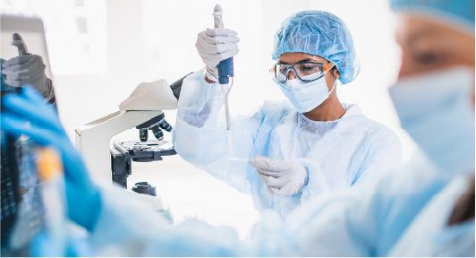 Woman in full protective equipment titrating onto sample slide