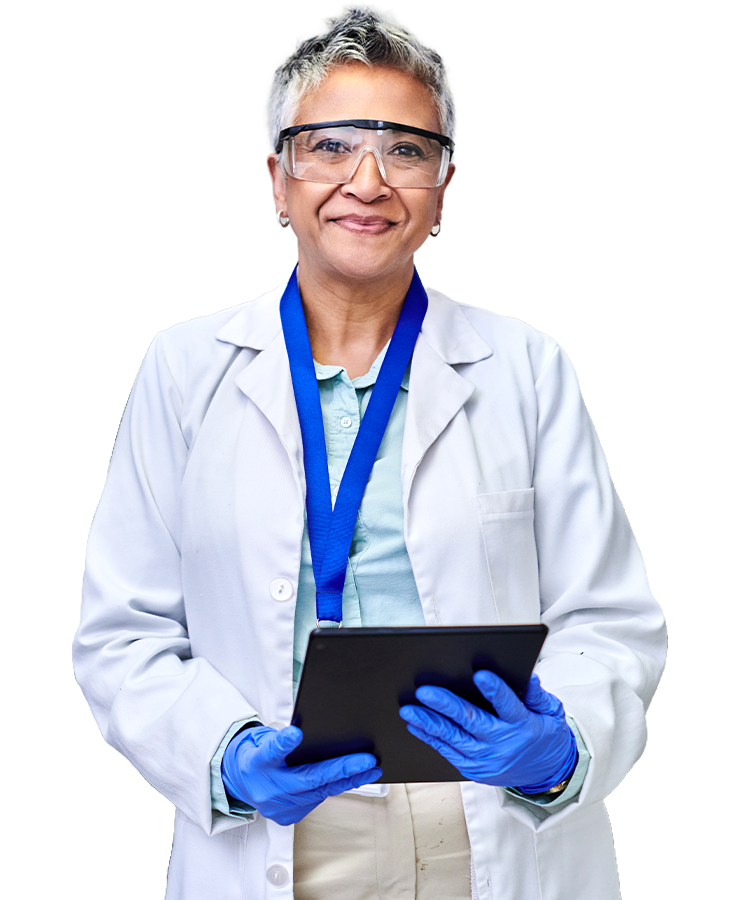 Female scientist in lab coat, goggles and gloves smiling with a tablet in her hands