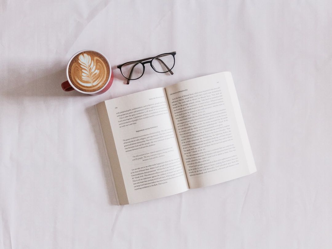 and image of an open book , glasses and a cup of coffee