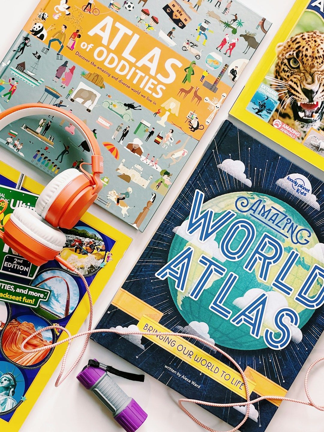 Several different atlases lined up diagonally to represent places to visit in the world.