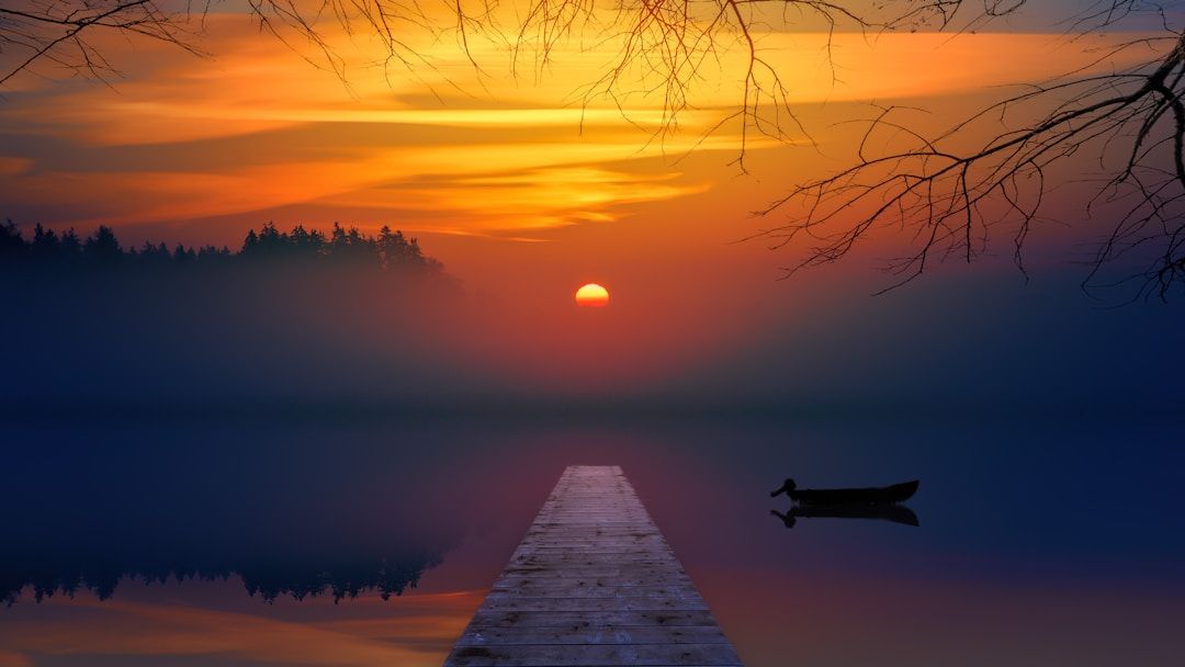 pier over lakes edge at sunrise