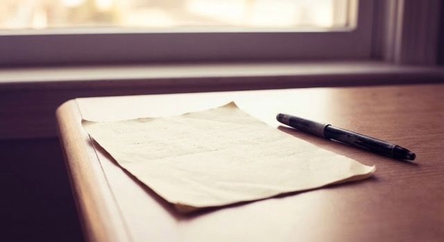 A vintage compass resting on soft purple fabric, symbolising finding your own direction