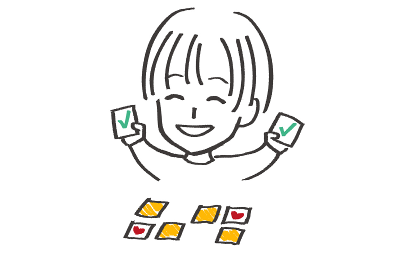Braini, our cheerful brand character, playing a memory card game and happily holding up two matching cards, symbolizing fun vocabulary practice and memory training.