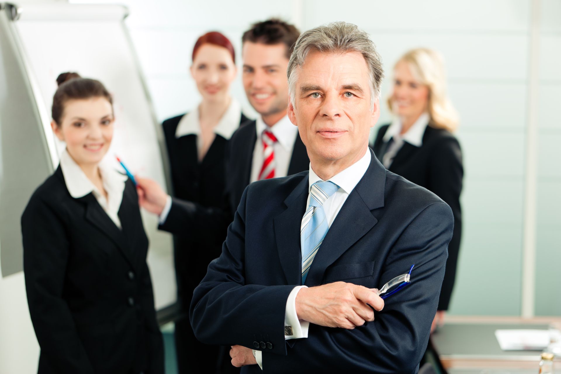 Manager in team meeting listens to colleague