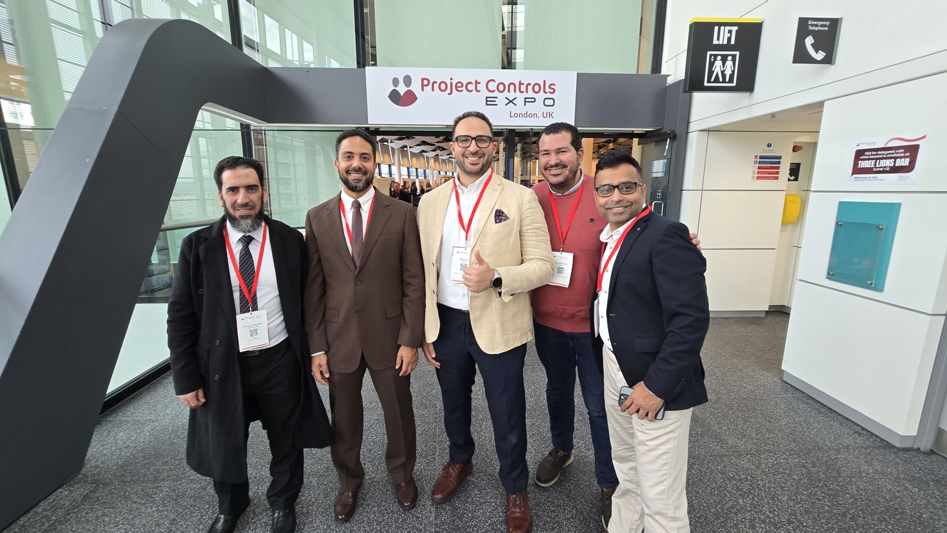 IQRM team at the Project Controls Expo London entrance arch
