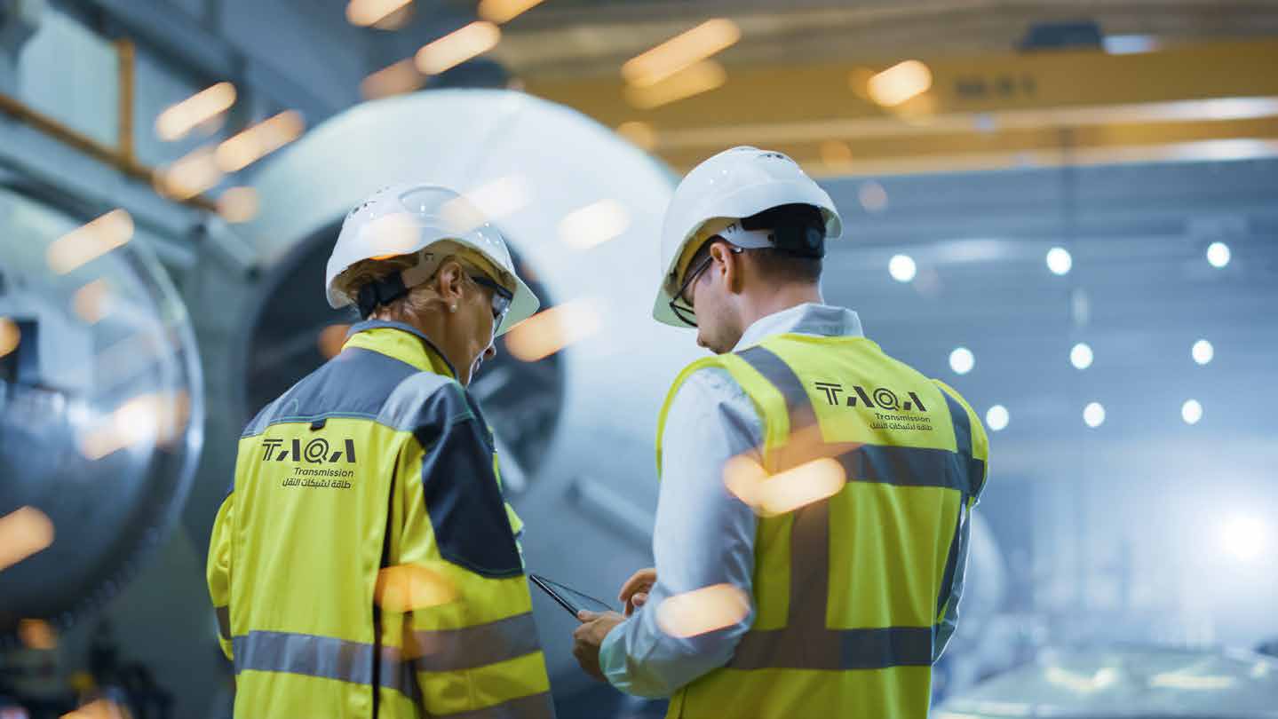 TAQA Transmission team members in safety helmets and high-visibility vests