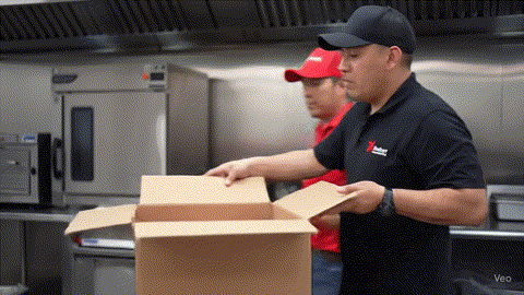 Latino food manager carefully inspecting a delivery box