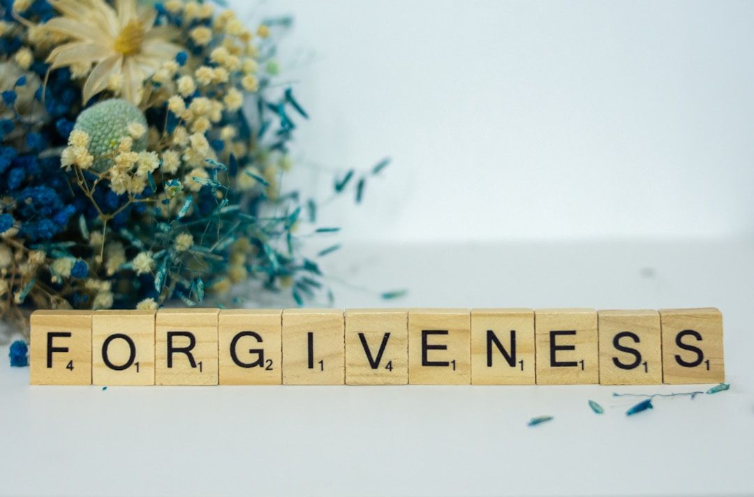 scrabble tiles lined up to say forgiveness - the siddhi of gene key 4
