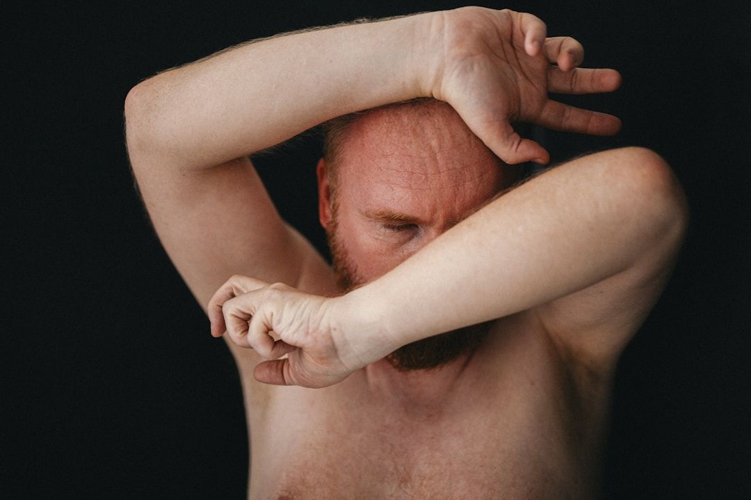 man struggling - a representation of discord and the struggle to learn from our past in the shadow of gene key 13