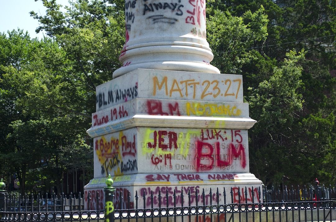 a statue covered in graffiti to represent gene key 7 and the shadow of division