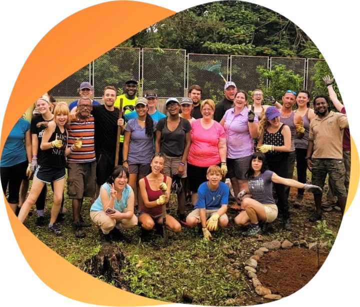 Group of international volunteers planting trees in a community garden
