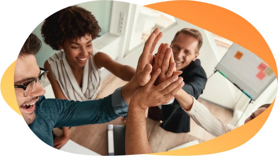 Diverse business team giving high five in office