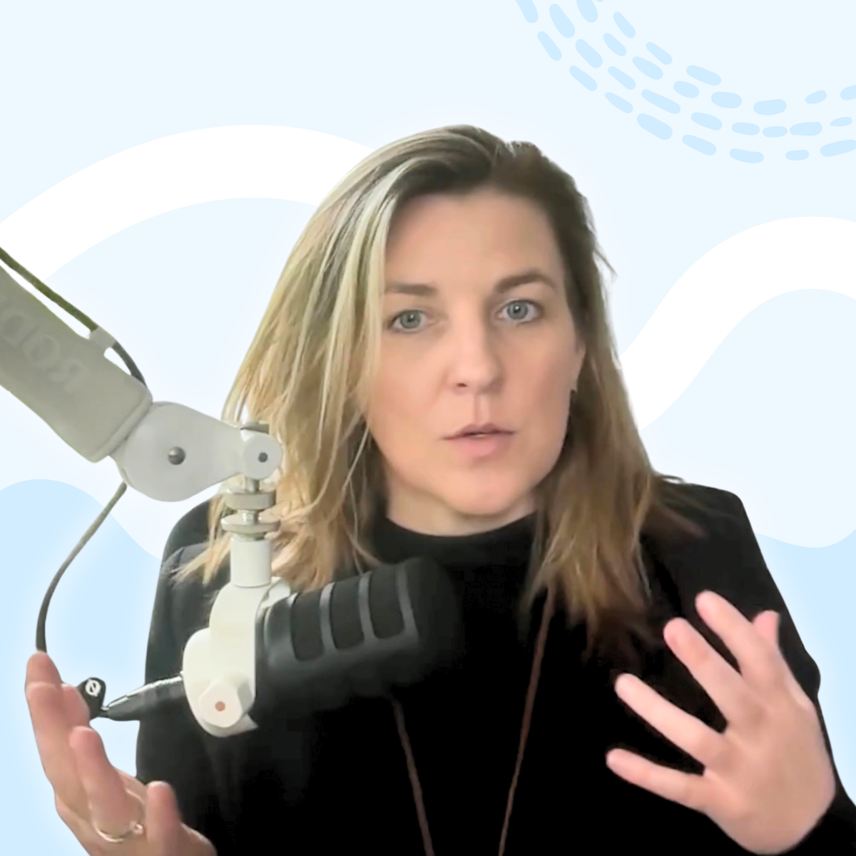 A photograph of Dr. Megan Anna Neff speaking into a podcast microphone.